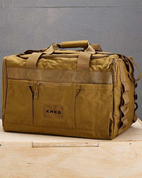 Large desert CORE Duffel sitting on wooden box