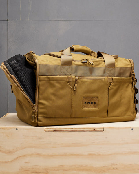 NOBULL sneakers packed inside large desert CORE Duffel shoe compartment