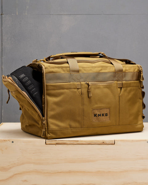 NOBULL sneakers packed inside desert CORE Duffel shoe compartment