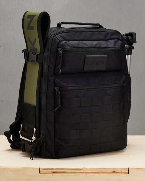 Weight lifting belt attached to side of Small black KNKG CONQUER Backpack with buckles
