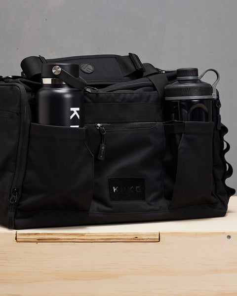 KNKG Drink bottle and Blender Shaker Bottle packed inside black CORE Duffel bottle pockets