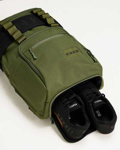 Sneakers inside of large green CORE Backpack shoe compartment