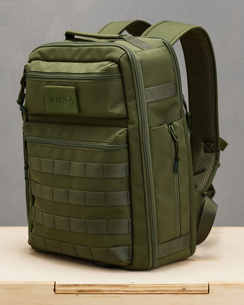 Side profile view of small green KNKG CONQUER Backpack