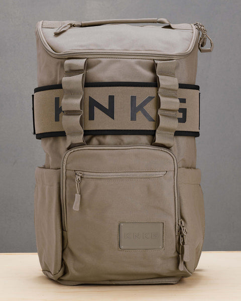 beige neutral CORE Backpack sitting on box with matching lifting belt