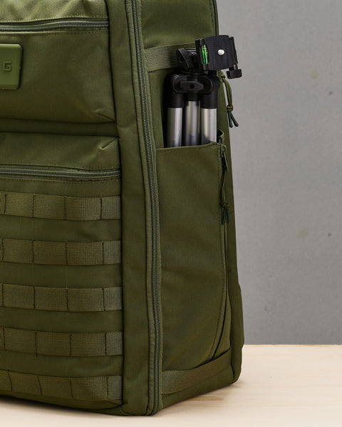 Tripod inside bottle pocket on side of  large green CONQUER Backpack