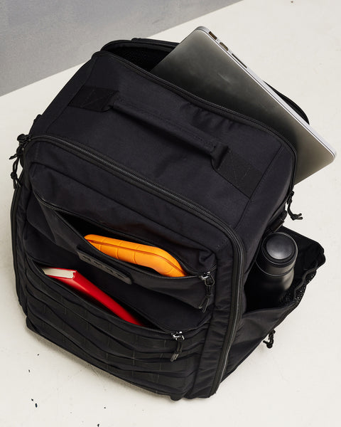 Laptop inside sleeve of large black CONQUER Backpack