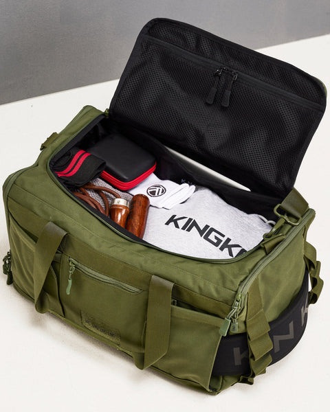 Birds eye view of green CORE Duffel packed with skipping rope, wrist wraps, laptop, lifting belt and gym towel.
