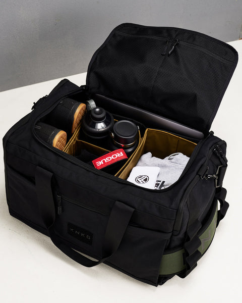 Birds eye view of internal divider organization system packed inside large black KNKG CORE Duffel