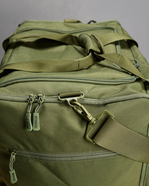 Close up of large green CORE Duffel zippers and buckles