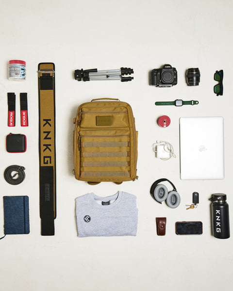 Flat lay of gym gear packed in Small desert KNKG CONQUER Backpack