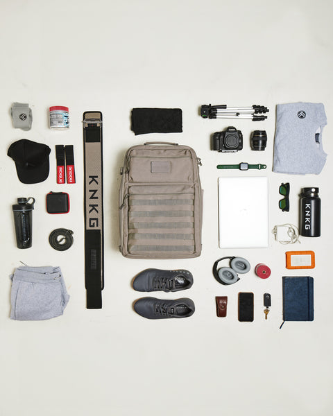 flat lay of gear gear being packed in beige neutral large KNKG CONQUER Backpack