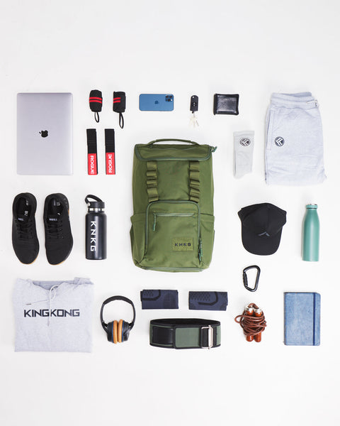 Flat lay of gym gear that fits inside of CORE Backpack
