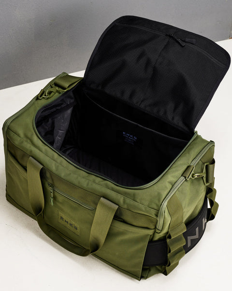 Birds eye view of empty large green CORE Duffel, showing internal pockets and compartments