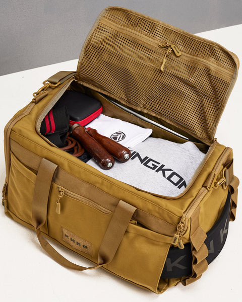 Birds eye view of desert CORE Duffel packed with hoodie, skipping rope, wrist wraps, socks and laptop