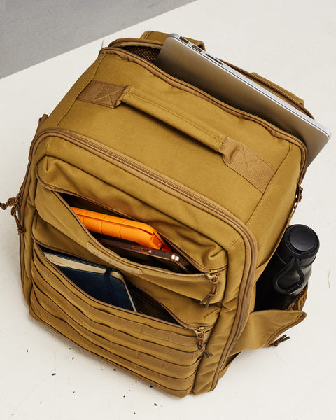 External pockets of desert KNKG CONQUER Backpack packed with drink bottle, phone, power bank, notebook and laptop