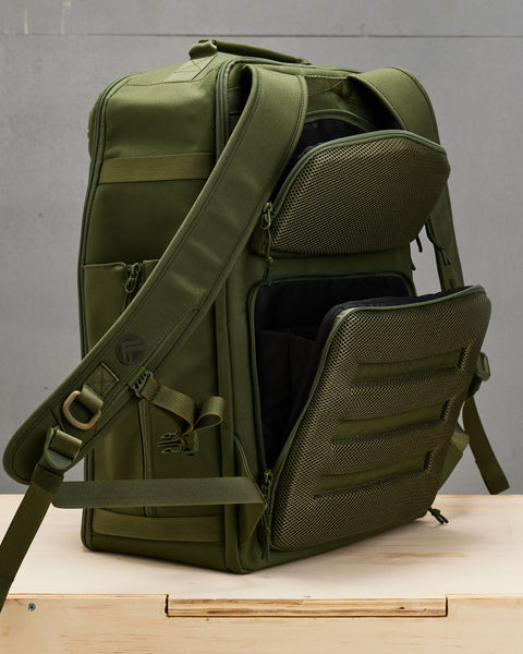 Concealed compartments on back of large green CONQUER Backpack