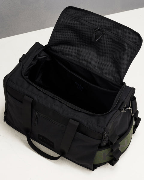 Birds eye view of empty black CORE Duffel, showing internal pockets and compartments