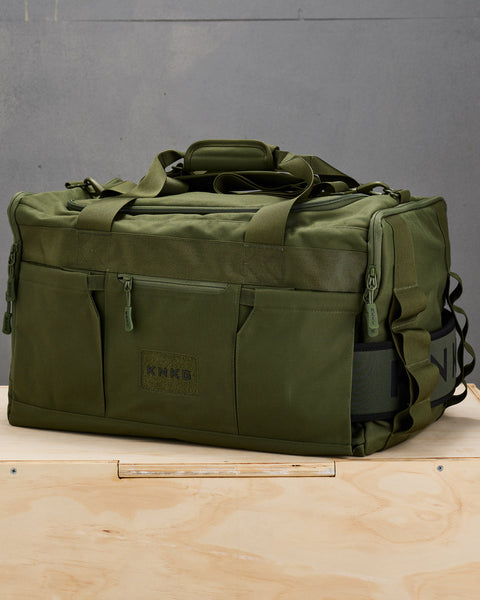 Side view of large green CORE Duffel showing matching weight lifting belt stored inside belt sleeve