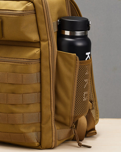 Close up of drink bottle inside pocket of Small desert KNKG CONQUER Backpack