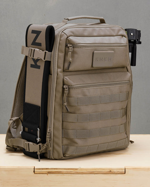 Matching weight lifting belt attached to side of neutral beige KNKG CONQUER backpack