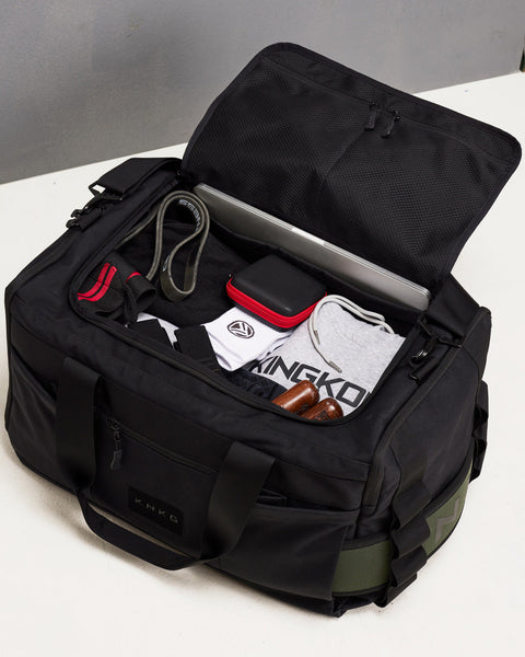 Birds eye view of large black KNKG CORE Duffel fully packed with gym gear