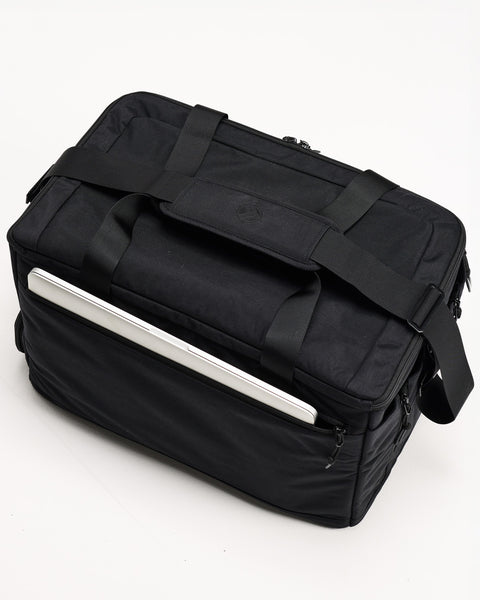 Top view of laptop inside sleeve of black CONQUER Duffel