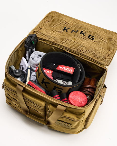 Inside view of gym essentials packed inside of desert CONQUER Duffel