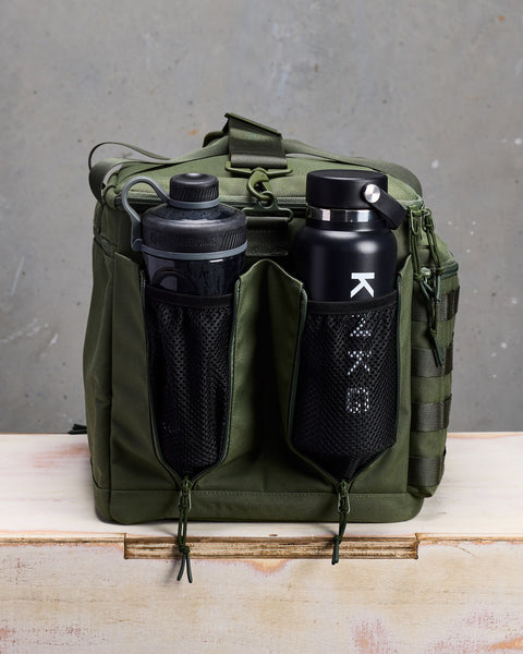 Close up of drink bottle and shaker inside mesh side pockets of Green KNKG CONQUER Duffel