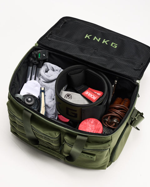 Birds eye view of Green KNKG CONQUER Duffel packed with gym gear