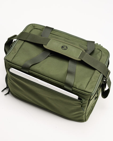 Top view of Green KNKG CONQUER Duffel  with laptop packed inside dedicated external sleeve