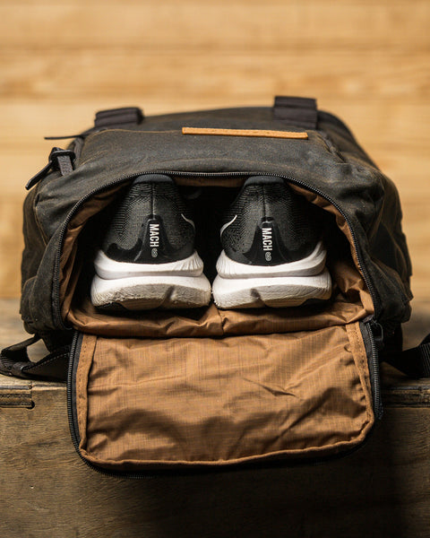 Sneakers inside bottom shoe compartment of KNKG Waxed Canvas Backpack
