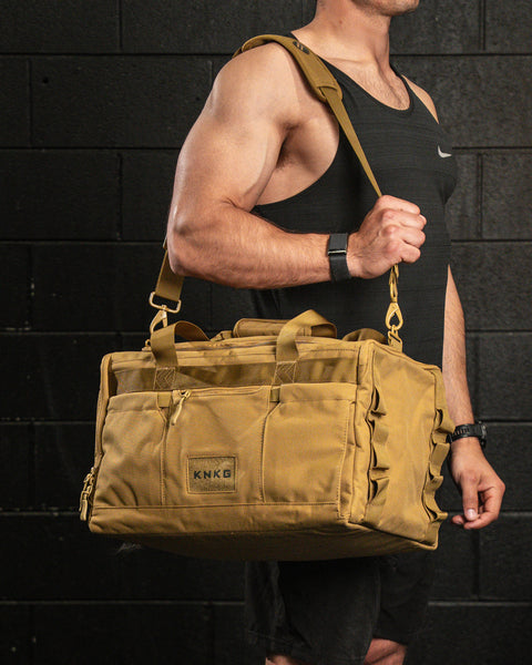 Athlete wearing desert CORE Duffel over shoulder