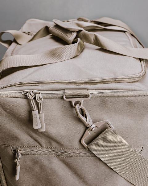 Close up of beige neutral CORE Duffel zippers and buckles