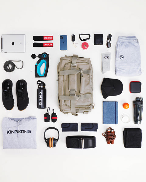 Flat lay of workout gear that fits inside beige neutral CORE Duffel