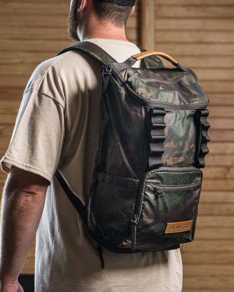 CORE Backpack in Camo Waxed Canvas being worn by athlete in gym