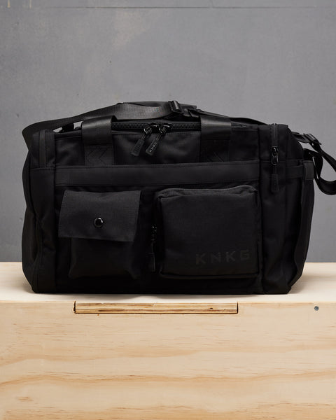 Front view of small black KNKG PLUS Duffel bag