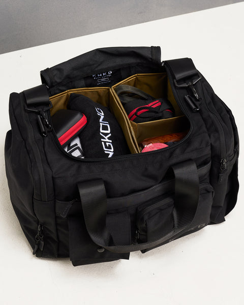 Birds eye view of divider organization inside small black KNKG PLUS Duffel bag