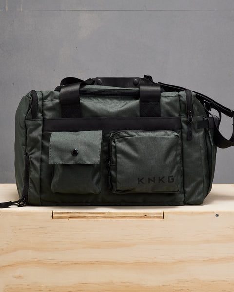 Front view of charcoal grey KNKG PLUS duffel bag