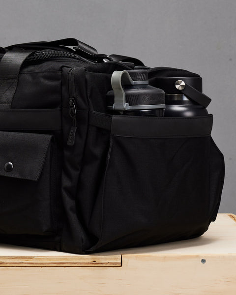 Shaker and water bottle packed in black KNKG PLUS duffel bag  pocket