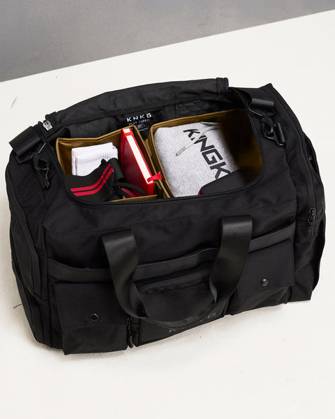 Birds eye view of internal organization system inside large black KNKG PLUS duffel bag