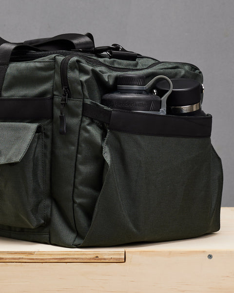 Blender bottle and water water packed inside charcoal grey PLUS Duffel