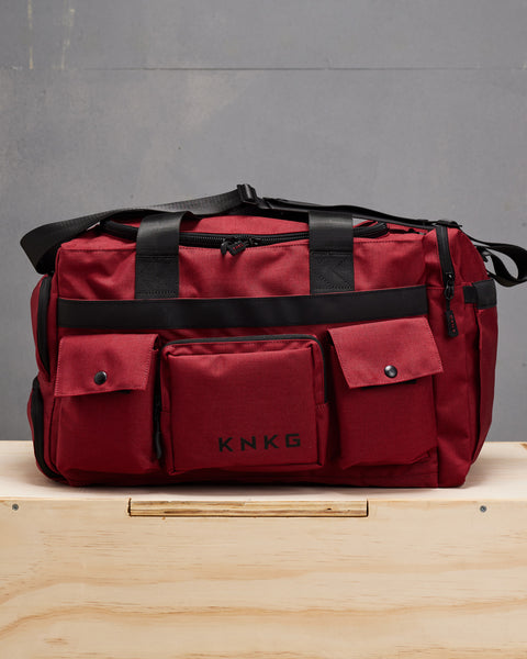 Front view of red KNKG PLUS Duffel