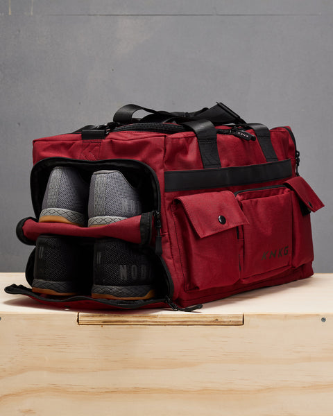 Red KNKG PLUS Duffel Shoe pocket with 2 pairs of sneakers