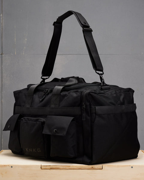 Side view angle of large black KNKG PLUS duffel