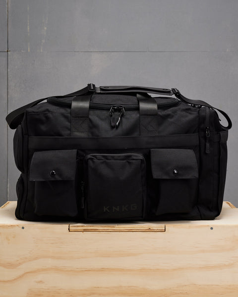 Front view of large black KNKG PLUS duffel