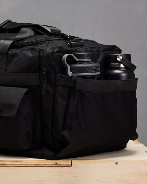Side bottle pockets on large black KNKG PLUS duffel