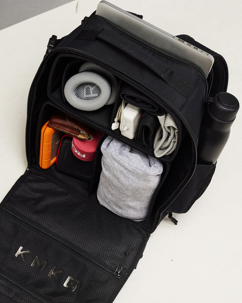 Internal view of neatly packed Small black KNKG CONQUER Backpack