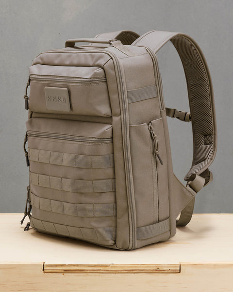 Side view of neutral beige KNKG CONQUER backpack