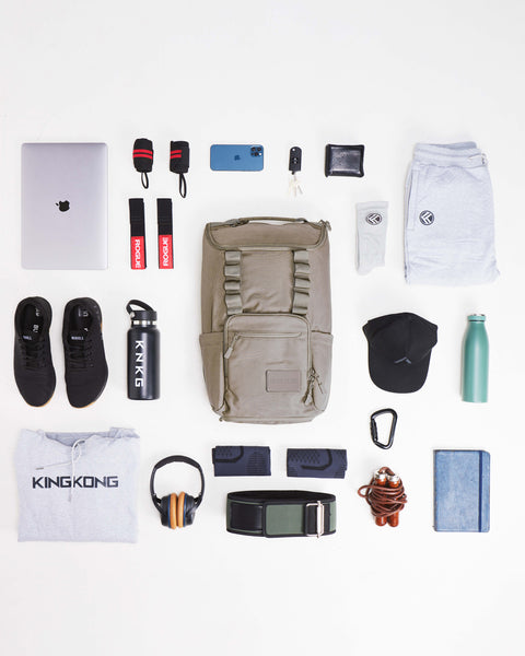 flat lay of items packed inside of beige neutral CORE Backpack
