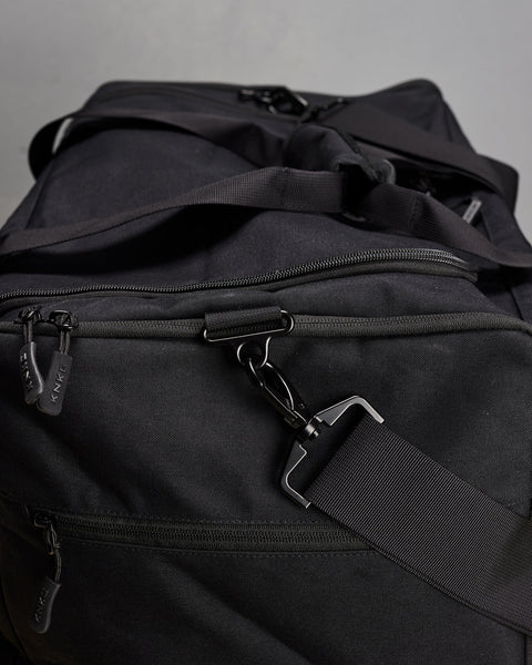 Close up of large black KNKG CORE Duffel zippers and buckles